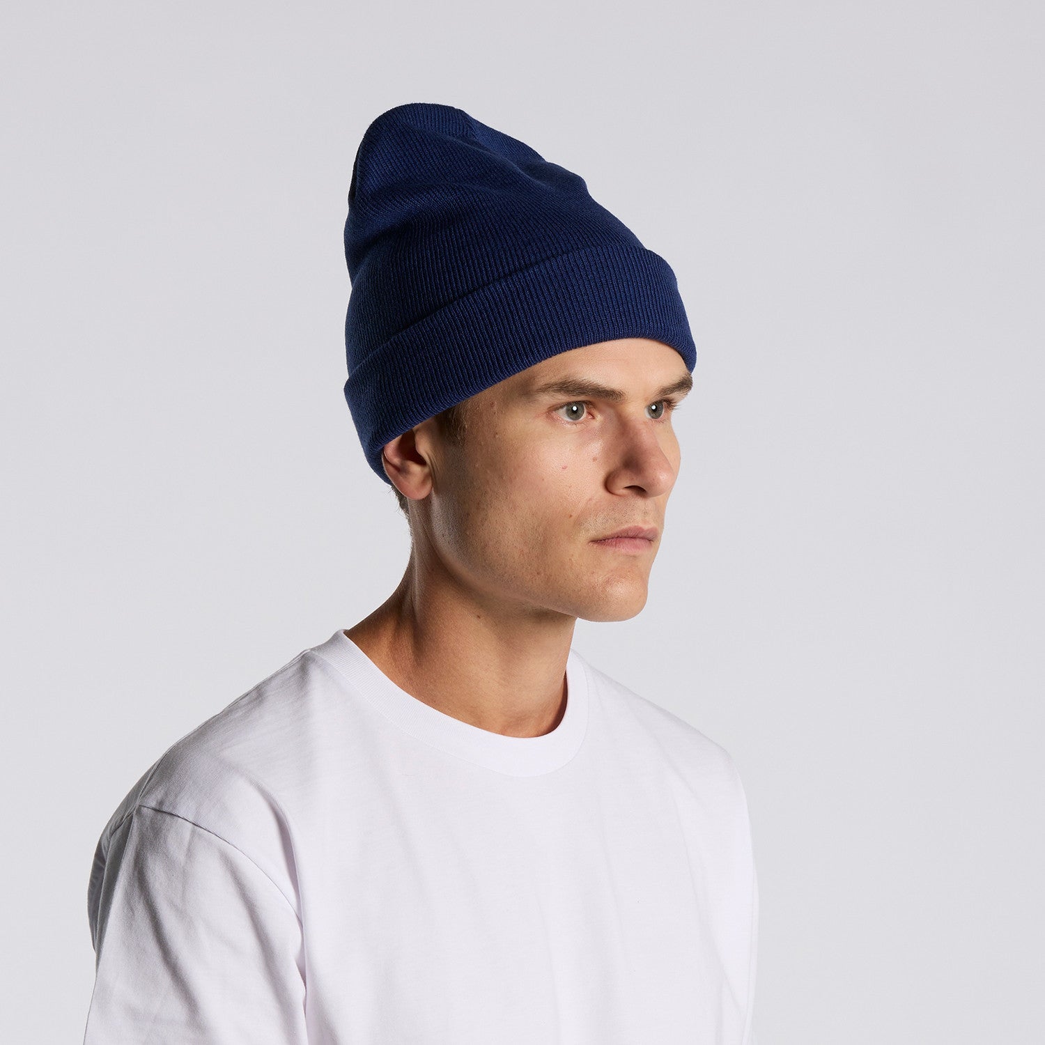 side image of model wearing as colour cable beanie in colour cobalt