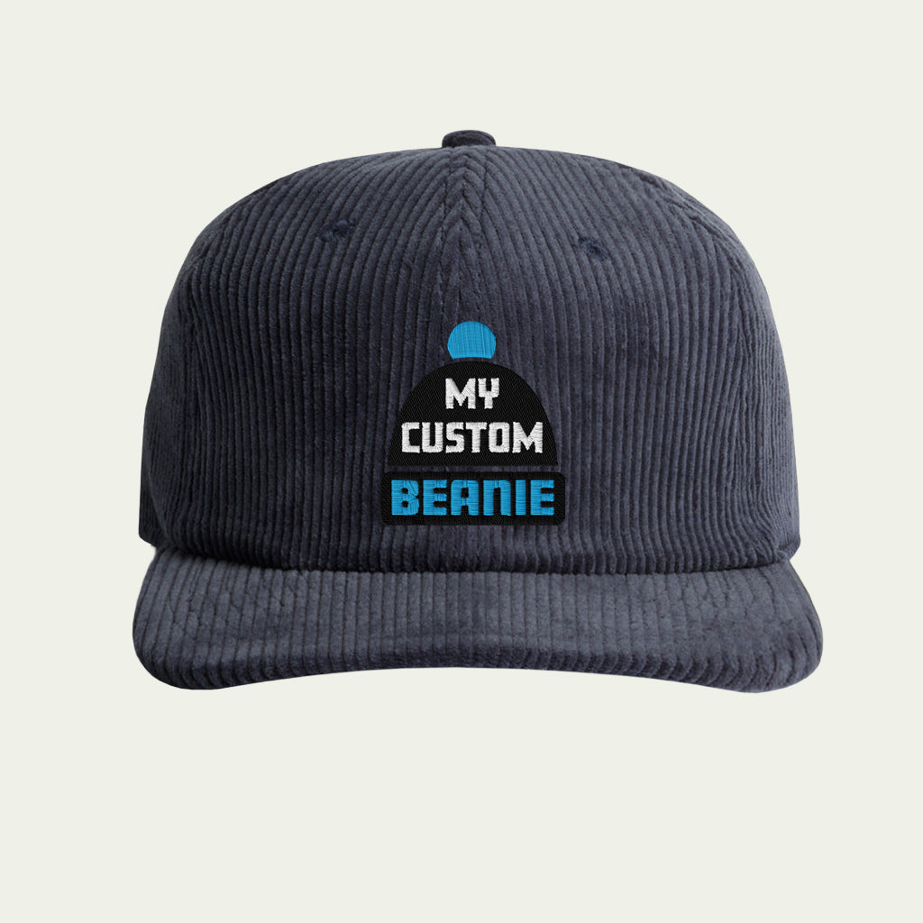Navy blue corduroy cap with 'My Custom Beanie' label on a beige background