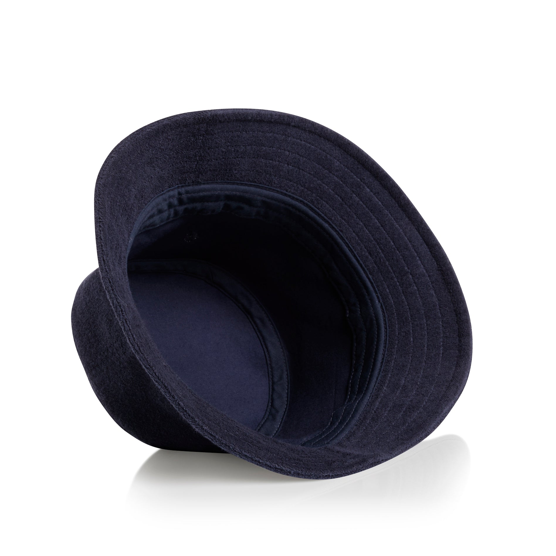 View of inside of navy as colour terry bucket hat on a white background