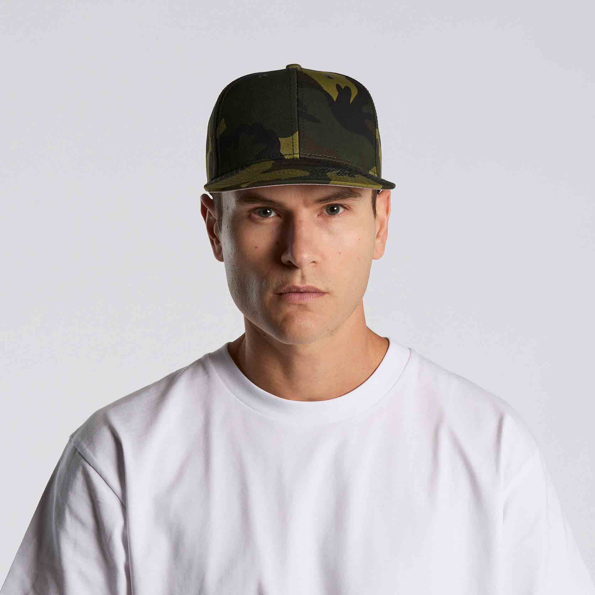 Man wearing as colour stock camo cap against a white background viewed from the front