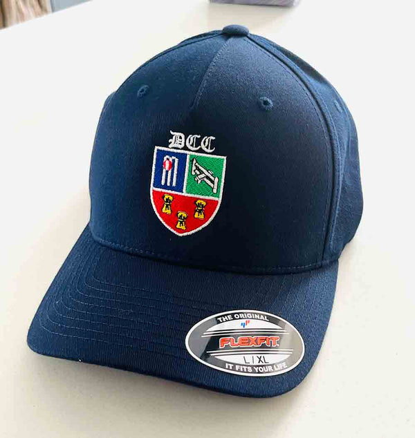 Navy blue cap embroidered with a cricket club logo on a light background