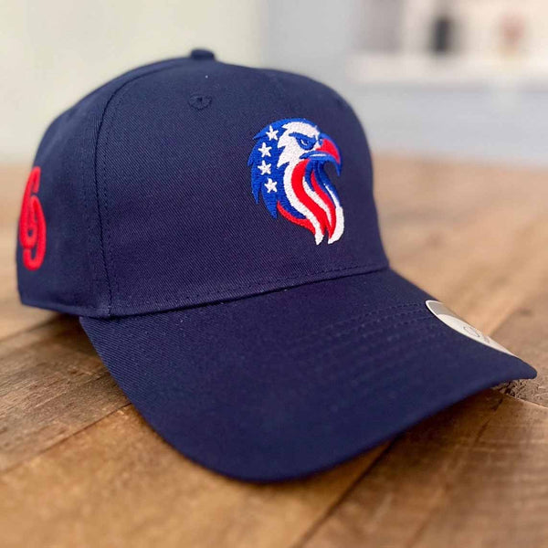 Navy blue cap embroidered with a coluorful logo on a wooden surface