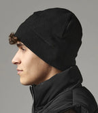 Image of model wearing Beechfield Suprafleece® Summit Hat in black on a grey background