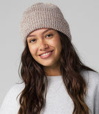 female model wearing beechfield campfire beanie in colour oatmeal speck shot on a grey background