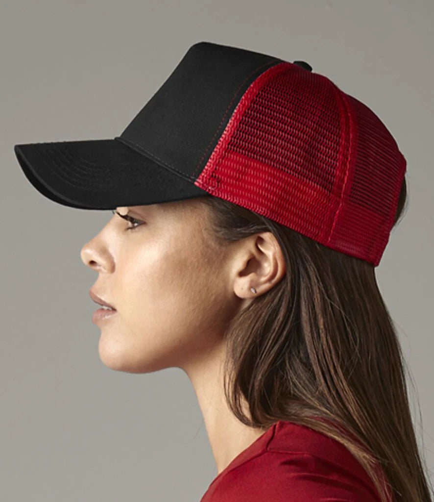 Product image of Beechfield Snapback Trucker Cap in black and classic red on a female model viewed from the side