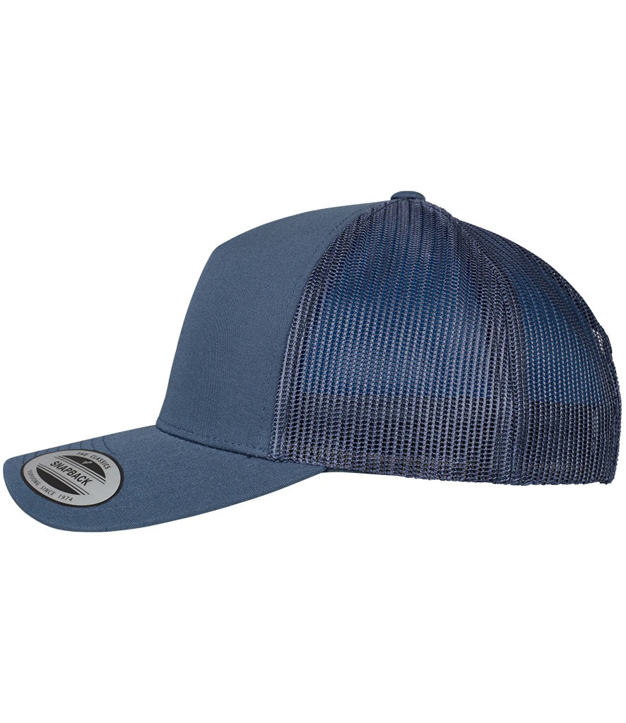 product image of flexfit 5 panel retro trucker cap in the colour navy viewed from the side photographed on a white background 