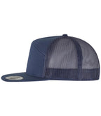 navy Flexfit 7 Panel Trucker Cap viewed from the side on a white background