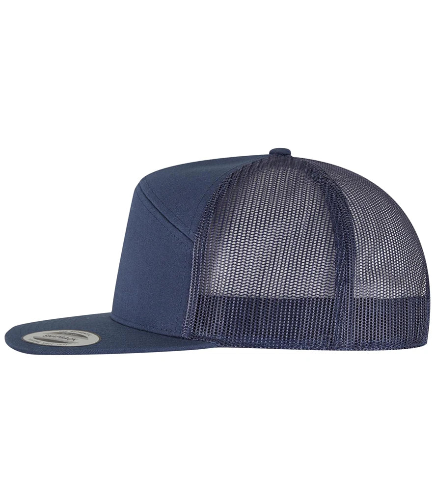 navy Flexfit 7 Panel Trucker Cap viewed from the side on a white background