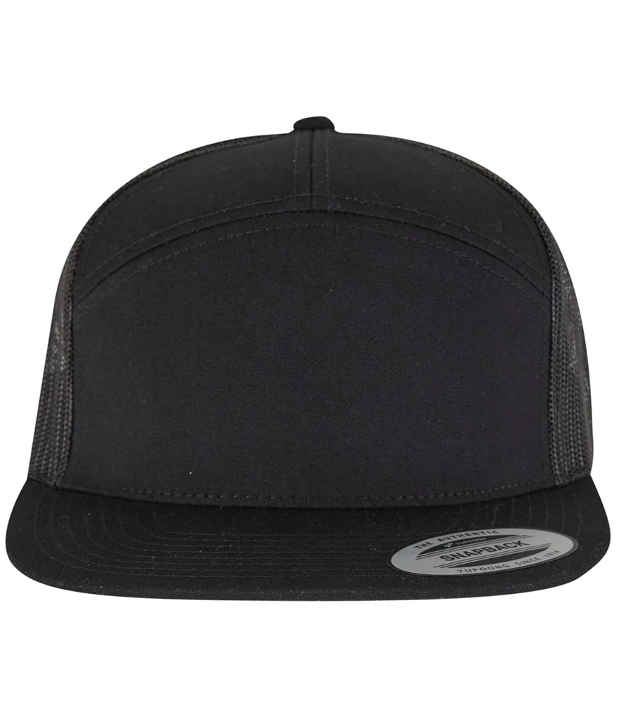 black Flexfit 7 Panel Trucker Cap viewed from the front on a white background