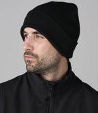 male model wearing pro rtx beanie in colour black photographed on a white background
