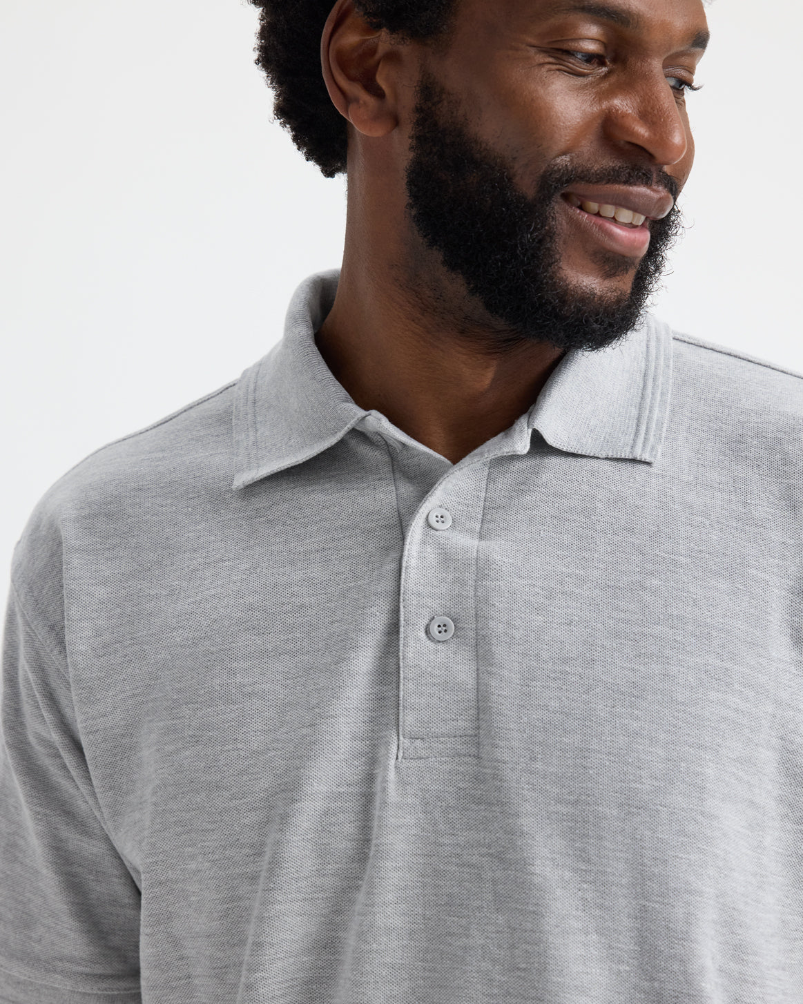 Model wearing uneek uc102 heavyweight polo-shirt in heather grey colour