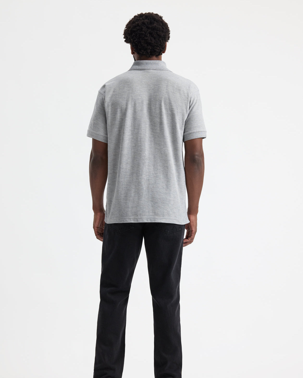 model wearing uneek uc102 heavyweight polo-shirt in heather grey colour from behind