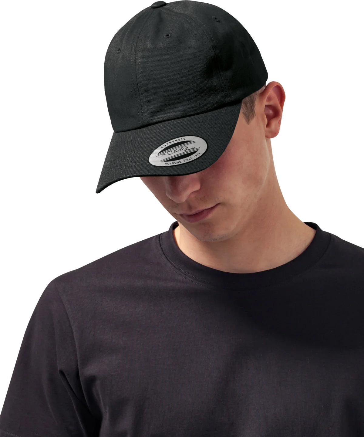 male model wearing Flexfit Low Profile Cotton Twill Cap in colour black pictured on a white background
