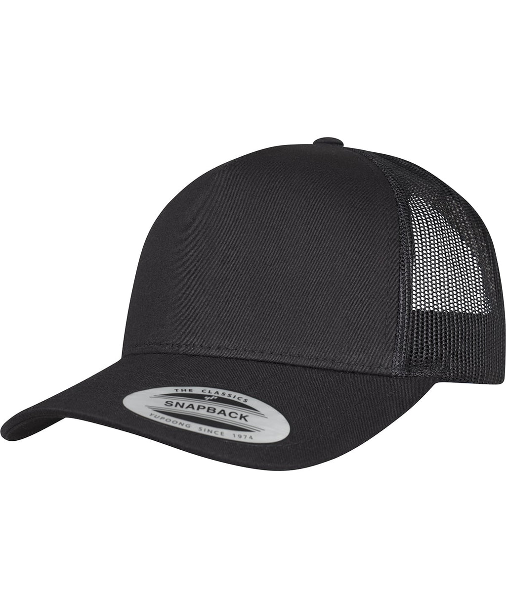 product image of flexfit 5 panel retro trucker cap in the colour black viewed from the front photographed on a white background 